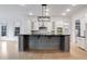 Open kitchen with gray island, stainless steel appliances, and ample lighting at 2733 Caldwell Rd, Brookhaven, GA 30319