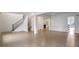 Bright open living area featuring hardwood floors, staircase, and access to the kitchen at 2733 Caldwell Rd, Brookhaven, GA 30319