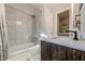 Updated bathroom with a tiled shower-tub, modern fixtures and wood vanity at 2736 Old Norcross Rd, Tucker, GA 30084