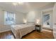 Bedroom with hardwood floors, a window, and a door to the hallway at 2736 Old Norcross Rd, Tucker, GA 30084