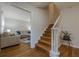Inviting entryway with hardwood floors, a staircase with white railings, and a glimpse into the cozy living room at 2736 Old Norcross Rd, Tucker, GA 30084