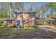 Charming two-story brick home with blue shutters, a covered carport, and lovely landscaping at 2736 Old Norcross Rd, Tucker, GA 30084