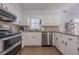 Efficient kitchen with stainless steel appliances, ample white cabinetry, and granite countertops at 2736 Old Norcross Rd, Tucker, GA 30084