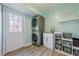 Functional laundry room with stacked washer and dryer, sink, and ample storage at 2736 Old Norcross Rd, Tucker, GA 30084