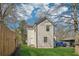 A view of the side and back yard, enclosed by a wooden fence and featuring lush green grass at 260 Westview Sw Pl, Atlanta, GA 30314