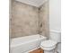 Bright bathroom featuring tile surround and flooring at 260 Westview Sw Pl, Atlanta, GA 30314