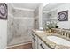 Modern bathroom featuring a shower with a tile surround and double sinks at 260 Westview Sw Pl, Atlanta, GA 30314