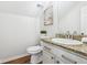Charming half bath featuring a granite countertop, hardwood floors, and decorative accents at 260 Westview Sw Pl, Atlanta, GA 30314