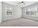 Spacious bedroom features neutral carpet, ceiling fan, and large windows at 260 Westview Sw Pl, Atlanta, GA 30314