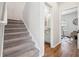 Hallway with carpeted stairs, wood floors, and access to an adjacent room at 260 Westview Sw Pl, Atlanta, GA 30314
