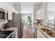 Open kitchen boasts stainless appliances, granite counters, and flows to dining area at 260 Westview Sw Pl, Atlanta, GA 30314