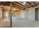 Unfinished basement with exposed rafters, a concrete floor and support beams at 2801 Univeter Rd, Canton, GA 30115