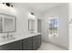 Bathroom featuring modern double vanity, a large mirror, modern lighting and window overlooking the front yard at 2801 Univeter Rd, Canton, GA 30115