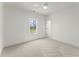 Bedroom featuring a neutral carpet, freshly painted white walls, and a large window at 2801 Univeter Rd, Canton, GA 30115