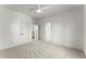 Carpeted bedroom with a ceiling fan, double closets and a view of the staircase to the second floor at 2801 Univeter Rd, Canton, GA 30115