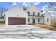 Charming two-story home with a two-car garage, fresh landscaping, and a paved driveway at 2801 Univeter Rd, Canton, GA 30115