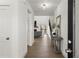 Bright hallway with hardwood floors, a modern light fixture, and views to the living room at 2801 Univeter Rd, Canton, GA 30115