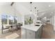 Modern open-concept kitchen with center island, dining area, and views to the living room at 2801 Univeter Rd, Canton, GA 30115