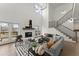 Spacious living room with high ceilings, fireplace, modern staircase, and outdoor access at 2801 Univeter Rd, Canton, GA 30115