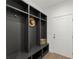 This mudroom features custom gray lockers and shelving with bench for seating at 2801 Univeter Rd, Canton, GA 30115
