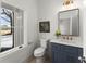 Modern powder room featuring a blue vanity, marble countertop, and stylish fixtures at 2801 Univeter Rd, Canton, GA 30115