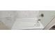 Clean white bathtub with marble-look tile surround at 3879 Artist Vw, Decatur, GA 30034
