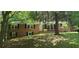 Classic brick home with black shutters, green lawn, and mature trees providing shade at 3879 Artist Vw, Decatur, GA 30034