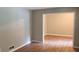 Open-concept living room with hardwood floors leading to another space at 3879 Artist Vw, Decatur, GA 30034
