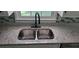 Close-up of the stainless steel kitchen sink and granite countertops at 3879 Artist Vw, Decatur, GA 30034
