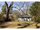 Large backyard with fire pit and rear house elevation at 1244 Lorenzo Sw Dr, Atlanta, GA 30310