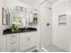 Elegant bathroom with white tile shower, modern vanity, and stylish mirror at 1244 Lorenzo Sw Dr, Atlanta, GA 30310