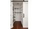 Custom closet with metal racking and barn door at 1244 Lorenzo Sw Dr, Atlanta, GA 30310