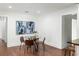 Cozy dining area featuring hardwood floors, modern art, and a glass-top table that seats four at 1244 Lorenzo Sw Dr, Atlanta, GA 30310