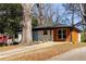 Charming renovated home with mixed siding, a bright blue front door, and mature trees at 1244 Lorenzo Sw Dr, Atlanta, GA 30310