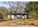 Back exterior view of the house with a covered patio and brick siding at 1244 Lorenzo Sw Dr, Atlanta, GA 30310