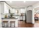 Bright kitchen with white cabinets, stainless steel appliances, granite countertops, and a breakfast bar at 1244 Lorenzo Sw Dr, Atlanta, GA 30310
