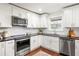Bright kitchen with white cabinets, stainless steel appliances, granite countertops, and a breakfast bar at 1244 Lorenzo Sw Dr, Atlanta, GA 30310