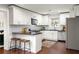 Bright kitchen with white cabinets, stainless steel appliances, granite countertops, and a breakfast bar at 1244 Lorenzo Sw Dr, Atlanta, GA 30310