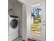 Laundry room featuring modern washer/dryer with access to backyard at 1244 Lorenzo Sw Dr, Atlanta, GA 30310