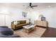 Bright living room with a modern ceiling fan, stylish furnishings, and sleek dark hardwood flooring at 1244 Lorenzo Sw Dr, Atlanta, GA 30310