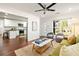 Open-concept living room featuring hardwood floors, modern decor, and seamless access to the adjacent kitchen at 1244 Lorenzo Sw Dr, Atlanta, GA 30310