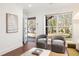 Open-concept living room featuring hardwood floors, modern decor, and seamless access to the front door at 1244 Lorenzo Sw Dr, Atlanta, GA 30310
