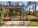 Backyard pergola with stone base, canopy top, and string lights at 1244 Lorenzo Sw Dr, Atlanta, GA 30310