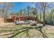 Home backyard featuring a deck, lawn, fence, and lush landscaping at 3398 Lori Ln, Atlanta, GA 30340