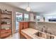 The bar area features granite countertops, a stainless steel sink, and convenient bar and storage shelving at 3398 Lori Ln, Atlanta, GA 30340