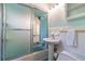 Bright bathroom featuring a pedestal sink, tub, and tiled walls at 3398 Lori Ln, Atlanta, GA 30340