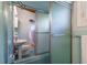 Bathroom featuring a pedestal sink, tiled shower, and charming vintage fixtures at 3398 Lori Ln, Atlanta, GA 30340