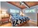 This main bedroom has an eye-catching ceiling design, wood flooring, and windows at 3398 Lori Ln, Atlanta, GA 30340
