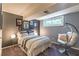 This bedroom has a large window, stylish decor, and a cozy reading nook at 3398 Lori Ln, Atlanta, GA 30340