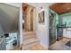 Hallway and stairs lead to the kitchen with stainless steel appliances and green backsplash at 3398 Lori Ln, Atlanta, GA 30340